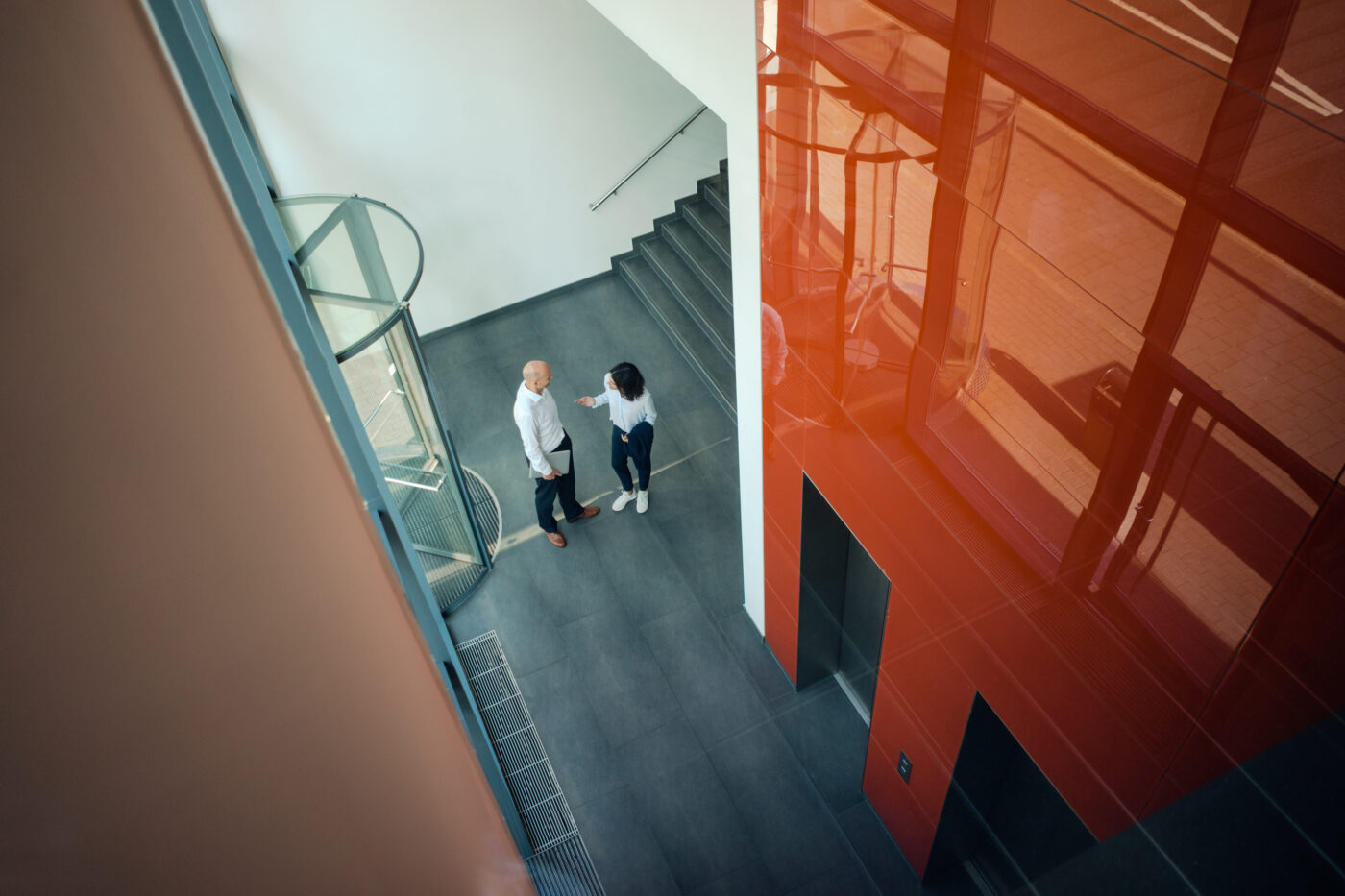 Business people talking in front of elevator
